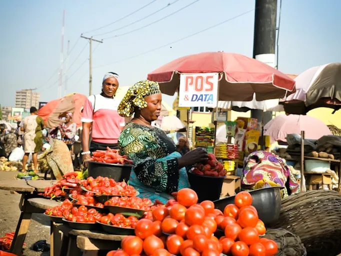 Group of traders at a market with fresh tomatoes